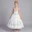 Front view of girls white formal dress with silver embroidered bodice, beaded shoulder fringe and sparkling tulle skirt